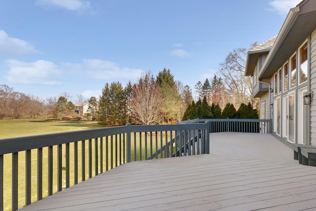 wooden terrace featuring a lawn