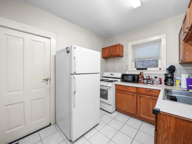 2124 W 24th St, Chicago, IL 60608 - kitchen featuring light countertops, white appliances, backsplash, a sink, and brown cabinetry