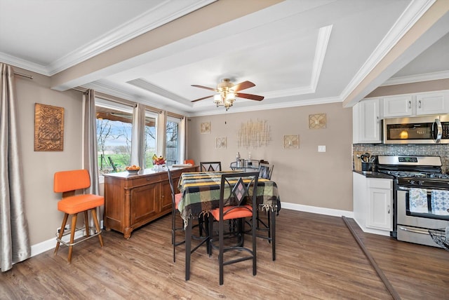 472 Lakewood Blvd, Park Forest, IL 60466 - dining space featuring a tray ceiling, wood finished floors, crown molding, and baseboards