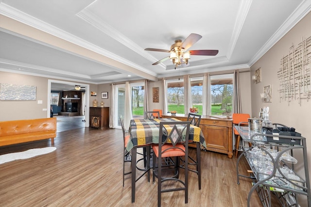 472 Lakewood Blvd, Park Forest, IL 60466 - dining room featuring a raised ceiling, wood finished floors, a ceiling fan, and crown molding