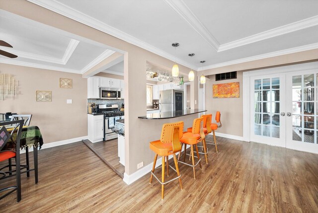 472 Lakewood Blvd, Park Forest, IL 60466 - kitchen with a breakfast bar, wood finished floors, french doors, appliances with stainless steel finishes, and white cabinetry