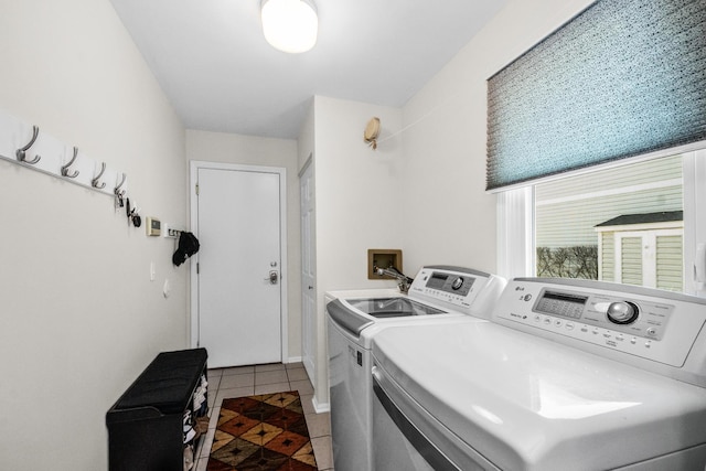 washroom featuring tile patterned flooring, washer and clothes dryer, and laundry area