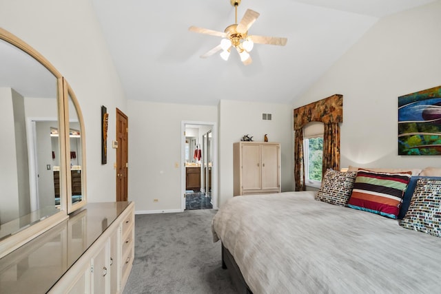 carpeted bedroom with ensuite bath, lofted ceiling, a ceiling fan, and baseboards