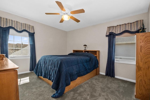 carpeted bedroom featuring baseboards and ceiling fan