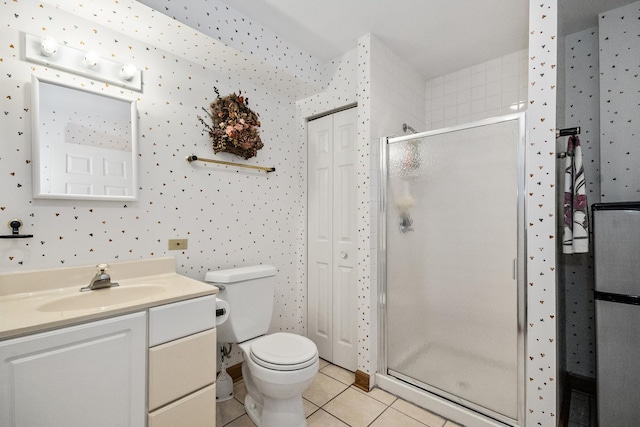 bathroom with vanity, tile patterned floors, a stall shower, and toilet