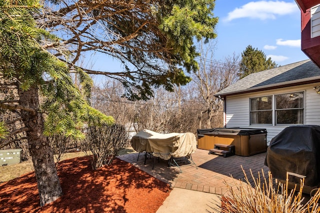 view of patio featuring a grill and a hot tub