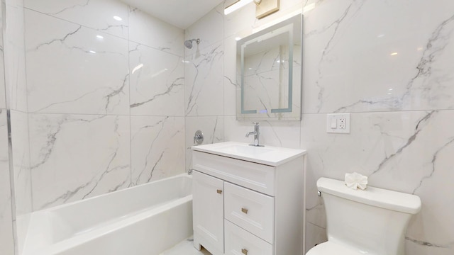 bathroom with vanity, tub / shower combination, toilet, and tile walls