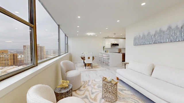 living area with recessed lighting and light wood finished floors