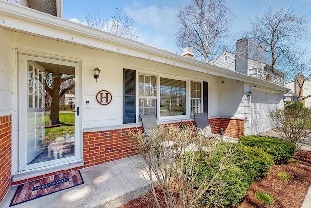1S550 Hawthorne Ln, Wheaton, IL 60189 - entrance to property with brick siding, a garage, driveway, and covered porch