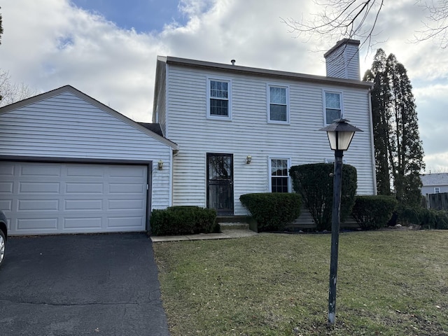 7 Pembroke Cir, Streamwood, IL 60107 - view of front of house with asphalt driveway, a chimney, a front yard, and an attached garage