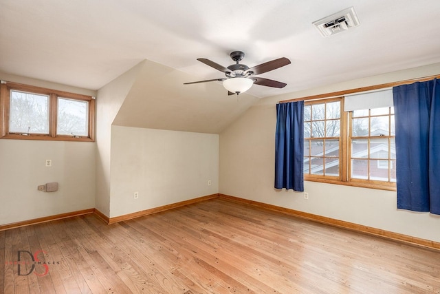 bonus room featuring vaulted ceiling, a ceiling fan, baseboards, visible vents, and hardwood / wood-style floors