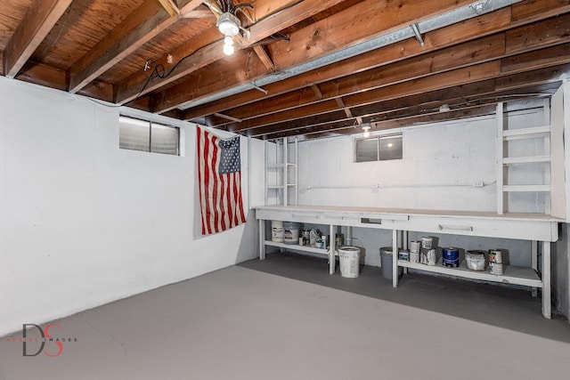 unfinished basement with a workshop area