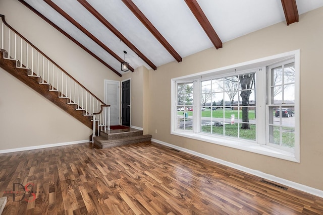 unfurnished living room with baseboards, visible vents, and plenty of natural light