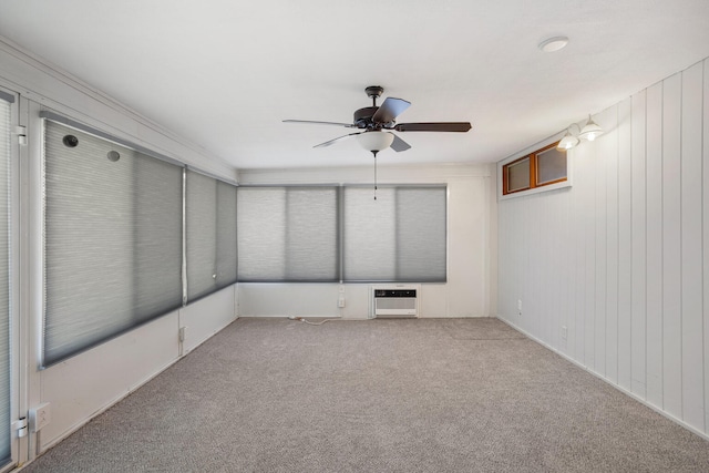 unfurnished room with light carpet, a ceiling fan, and heating unit