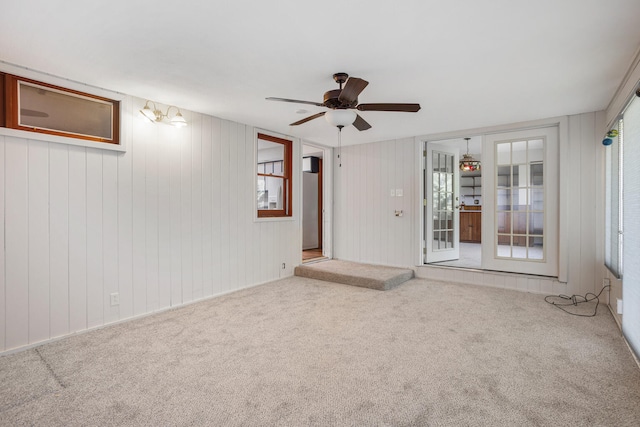 spare room with carpet flooring, ceiling fan, and plenty of natural light