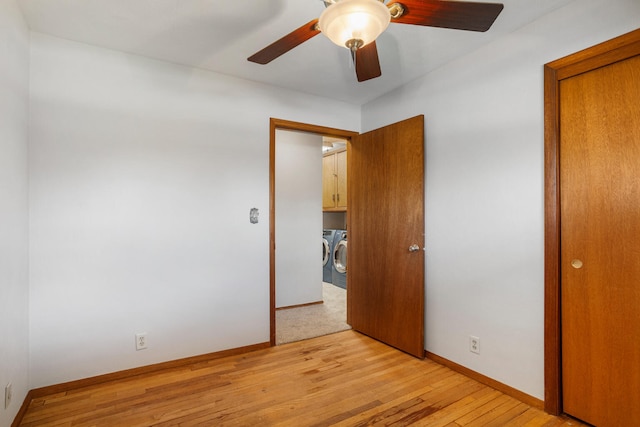 unfurnished bedroom with baseboards, a ceiling fan, light wood-style floors, and independent washer and dryer