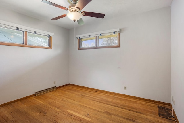 unfurnished room with visible vents, a ceiling fan, light wood-style flooring, and baseboards