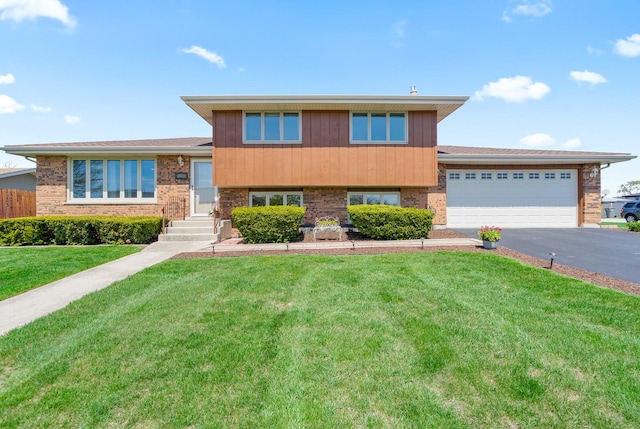 8900 W 169th Pl, Orland Hills, IL 60487 - split level home with driveway, a front lawn, a garage, and brick siding
