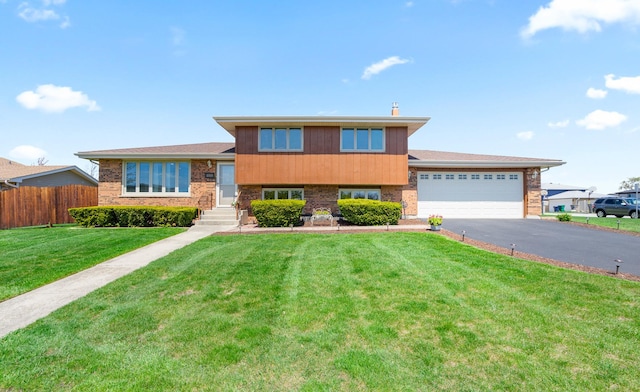 8900 W 169th Pl, Orland Hills, IL 60487 - tri-level home featuring asphalt driveway, a garage, and brick siding