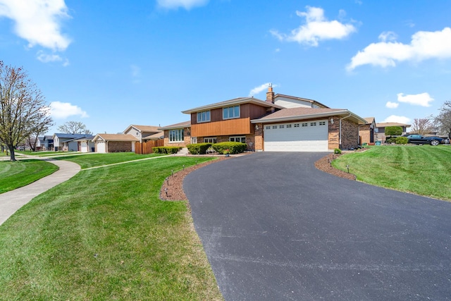 8900 W 169th Pl, Orland Hills, IL 60487 - tri-level home with brick siding, asphalt driveway, a garage, and a residential view