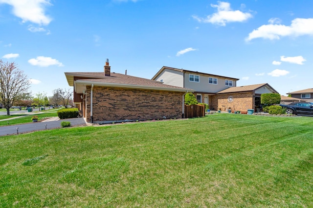 8900 W 169th Pl, Orland Hills, IL 60487 - view of side of property with brick siding, a lawn, and a chimney