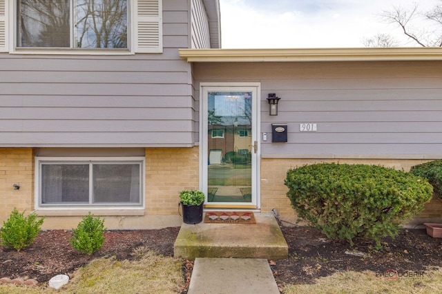 property entrance with brick siding
