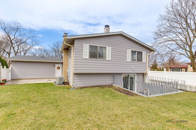 back of property with fence, cooling unit, a patio area, and a yard