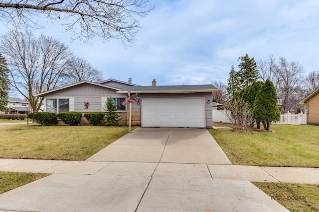 single story home featuring driveway, a front lawn, fence, and an attached garage