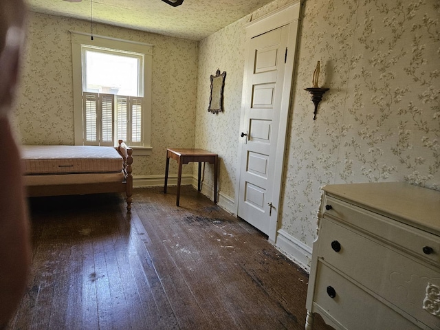 bedroom with dark wood-style flooring