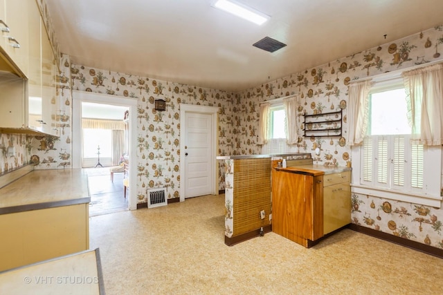 940 W Main St, Saint Charles, IL 60174 - kitchen featuring wallpapered walls, baseboards, light countertops, and light flooring