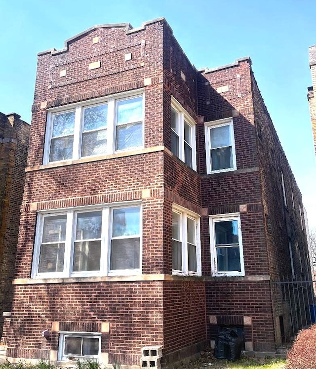 view of property exterior featuring brick siding