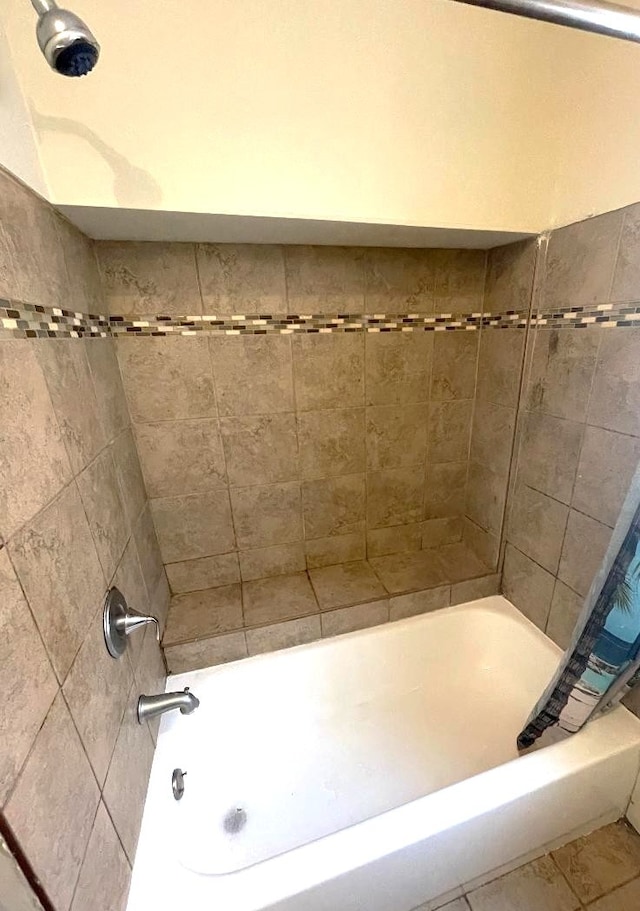 bathroom featuring tile patterned flooring and shower / bath combo with shower curtain