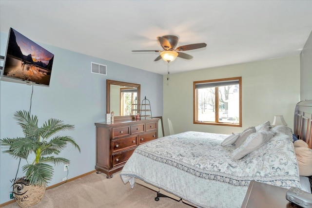 bedroom with light carpet, visible vents, baseboards, and a ceiling fan