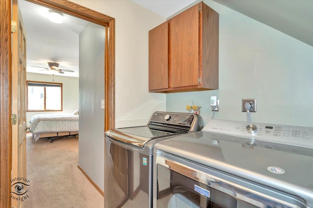 clothes washing area with light carpet, washing machine and dryer, a ceiling fan, and cabinet space