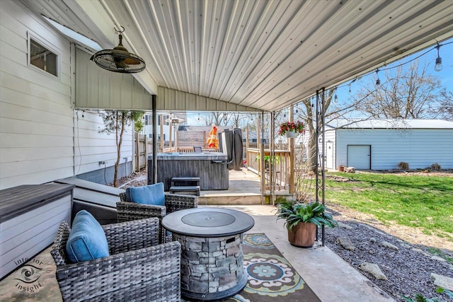 view of patio with an outbuilding and a hot tub