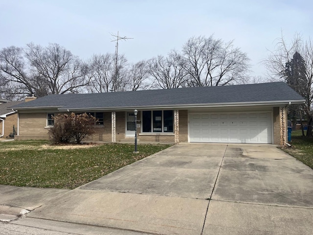 ranch-style home with an attached garage, concrete driveway, brick siding, and a front yard