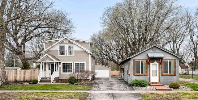 1207 Bunn St, Bloomington, IL 61701 - bungalow-style home with an outbuilding, a detached garage, and fence