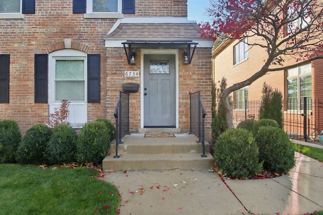 6734 N Hamlin Ave, Lincolnwood, IL 60712 - entrance to property with brick siding, a shingled roof, and a chimney