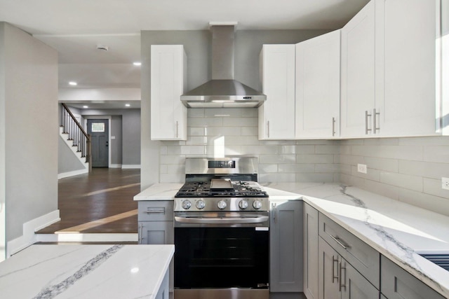 6734 N Hamlin Ave, Lincolnwood, IL 60712 - kitchen featuring gas range, wall chimney exhaust hood, baseboards, and decorative backsplash