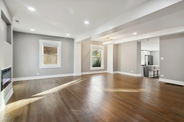 6734 N Hamlin Ave, Lincolnwood, IL 60712 - unfurnished living room with dark wood finished floors, recessed lighting, baseboards, and heating unit
