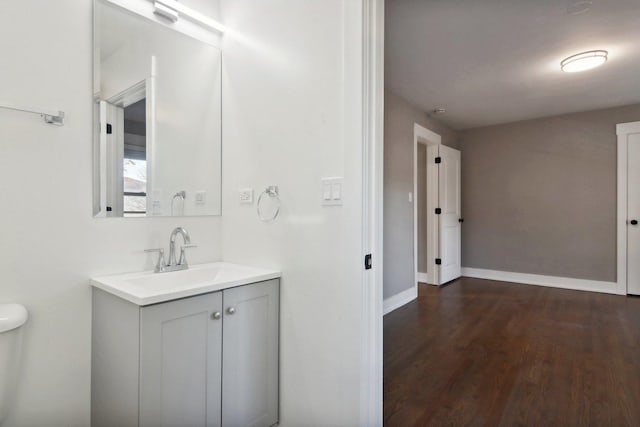 6734 N Hamlin Ave, Lincolnwood, IL 60712 - bathroom featuring wood finished floors, vanity, baseboards, and toilet