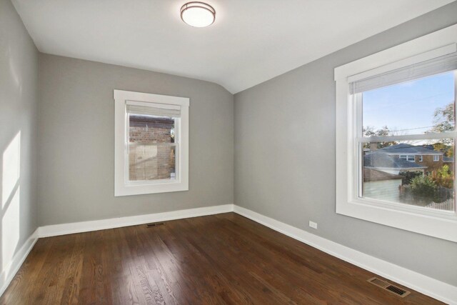 6734 N Hamlin Ave, Lincolnwood, IL 60712 - empty room with healthy amount of natural light, baseboards, dark wood-style floors, and lofted ceiling
