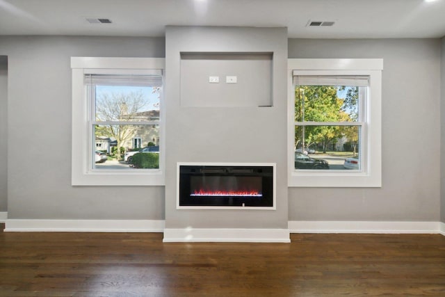 6734 N Hamlin Ave, Lincolnwood, IL 60712 - unfurnished living room with a glass covered fireplace, wood finished floors, and healthy amount of natural light