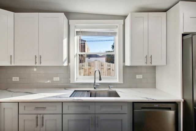 6734 N Hamlin Ave, Lincolnwood, IL 60712 - kitchen with appliances with stainless steel finishes, a sink, backsplash, and light stone countertops