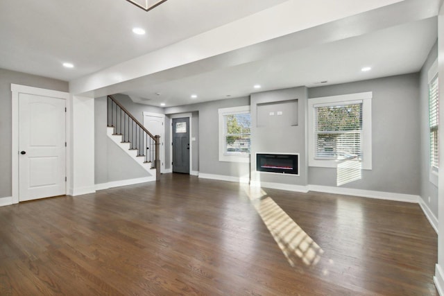 6734 N Hamlin Ave, Lincolnwood, IL 60712 - unfurnished living room with stairs, healthy amount of natural light, wood finished floors, baseboards, and recessed lighting