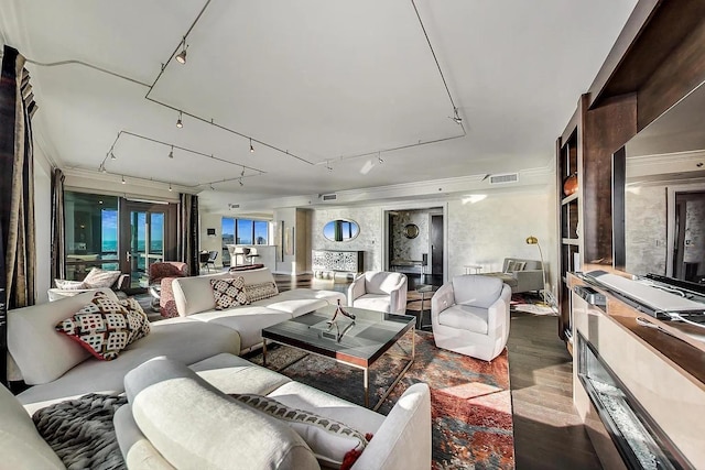 interior space with wood finished floors, rail lighting, and visible vents