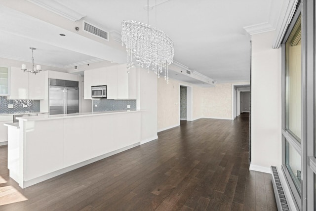 unfurnished living room with dark wood-type flooring, visible vents, an inviting chandelier, and crown molding