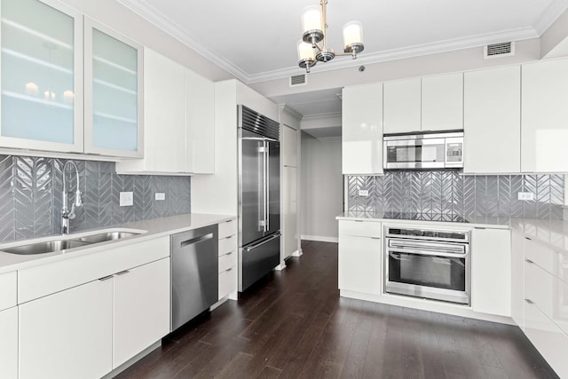 kitchen with light countertops, appliances with stainless steel finishes, a sink, and visible vents