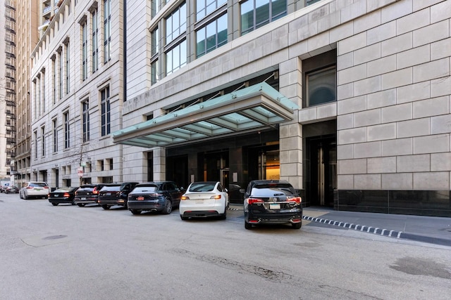 view of building exterior featuring uncovered parking