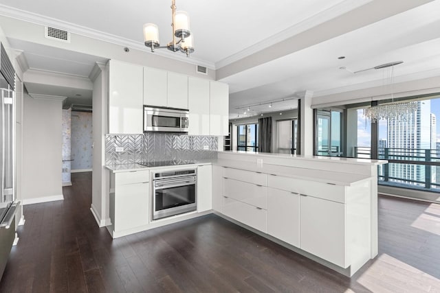 kitchen featuring modern cabinets, light countertops, an inviting chandelier, and stainless steel appliances